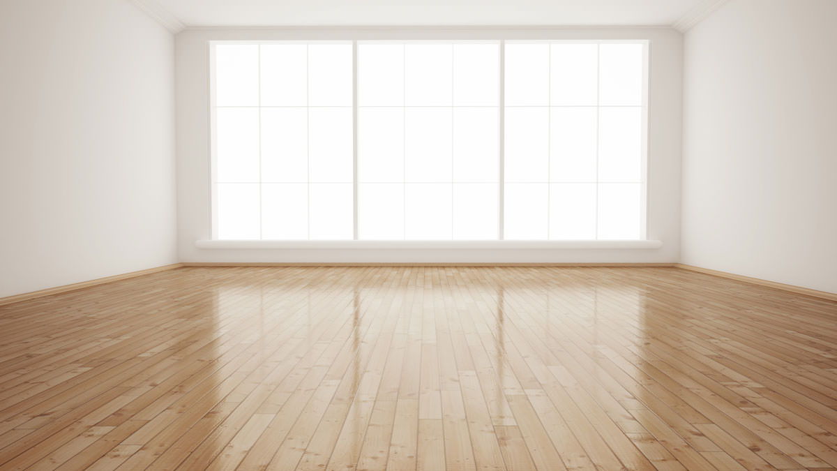 اتاق خالی و بدون وسایل که کف آن پارکت چوبی شده است و دیوارهای آن سفید رنگ است